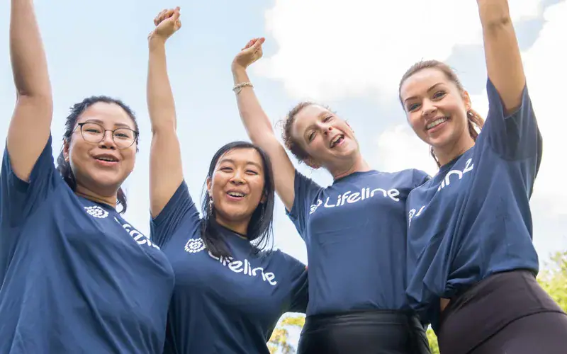 A cheering team of Lifeline fundraisers in blue shirts